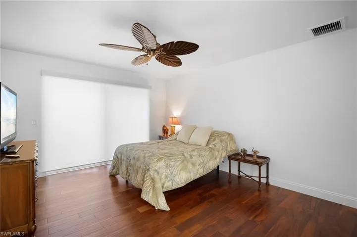 Bedroom featuring wood finished floors and ceiling fan