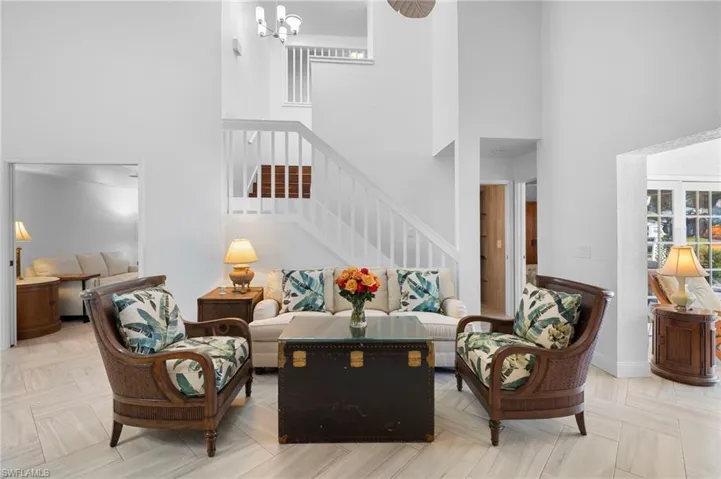 Living room with a high ceiling and a chandelier