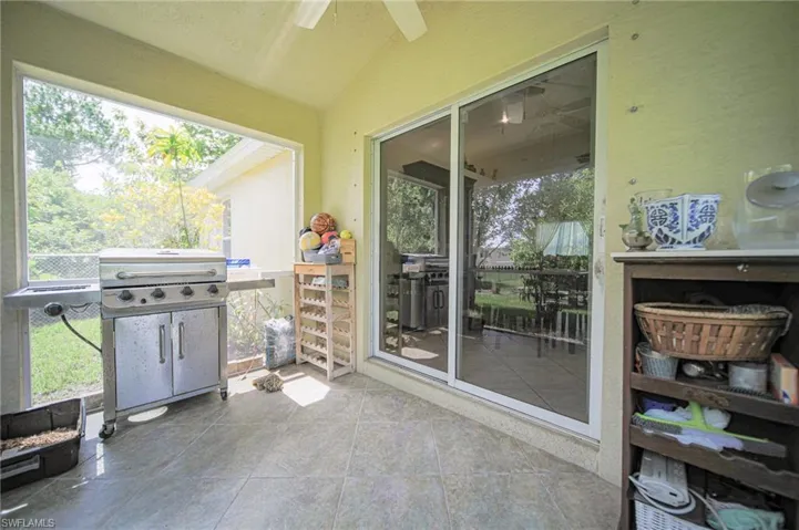 Sunroom / solarium with ceiling fan, vaulted ceiling, and plenty of natural light