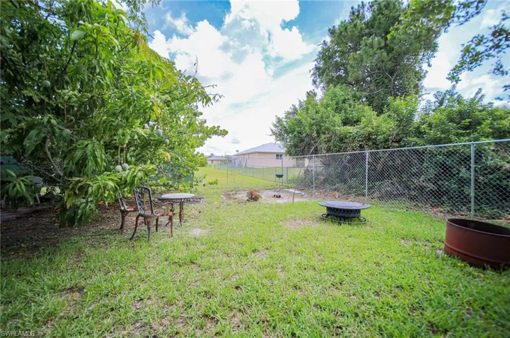 View of yard with an outdoor fire pit