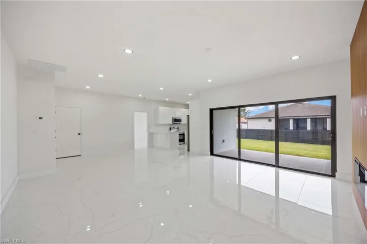 Empty room featuring light marble finish floors, recessed lighting, and baseboards