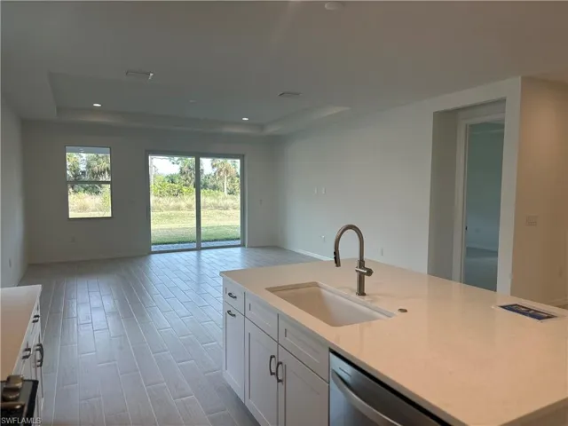 Open-concept kitchen and great room area with tray ceiling in great room