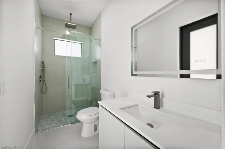 Bathroom with vanity and a shower stall