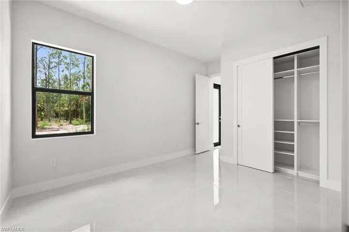 Unfurnished bedroom featuring light tile patterned flooring and a closet