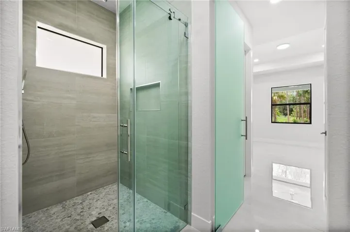 Full bathroom with a stall shower, recessed lighting, and tile patterned floors