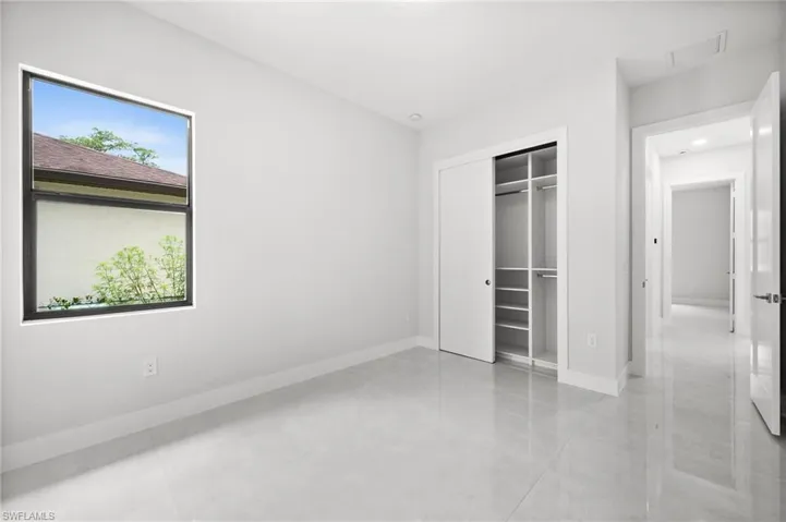Unfurnished bedroom with baseboards and a closet