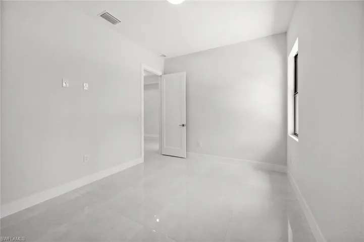 Spare room featuring baseboards