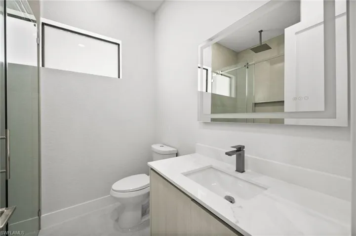 Bathroom featuring vanity and an enclosed shower