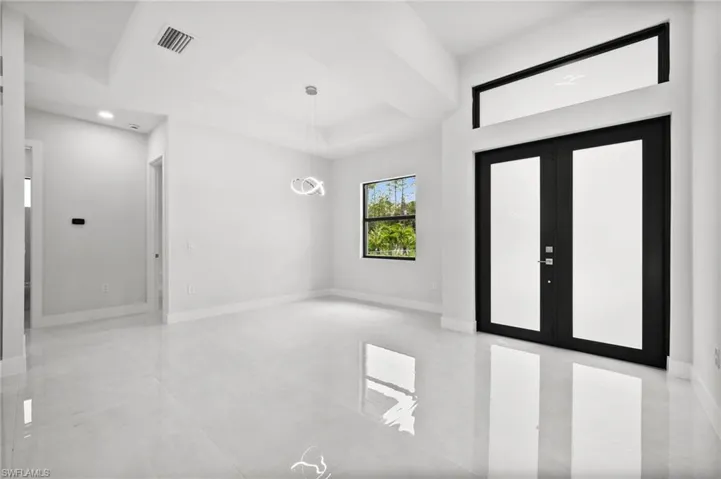 Entryway with recessed lighting and baseboards