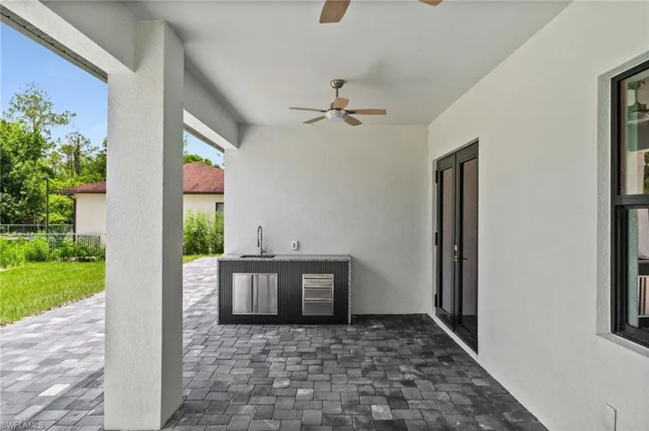 View of patio / terrace featuring ceiling fan and exterior kitchen