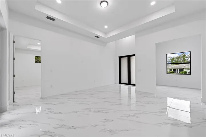 Spare room featuring a raised ceiling