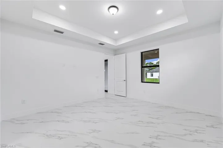 Spare room featuring a raised ceiling