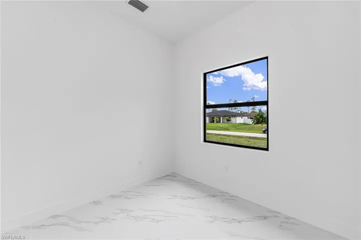 Unfurnished room featuring a wealth of natural light