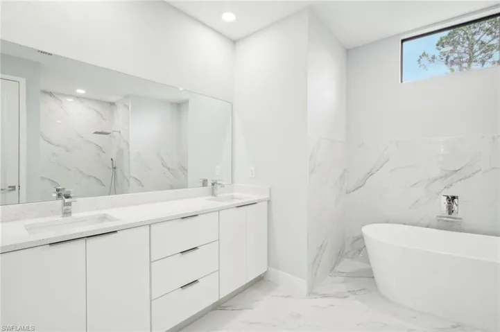 Bathroom with vanity and plus walk in shower