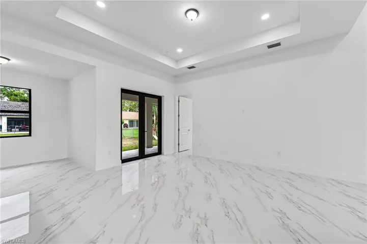 Unfurnished room featuring a tray ceiling