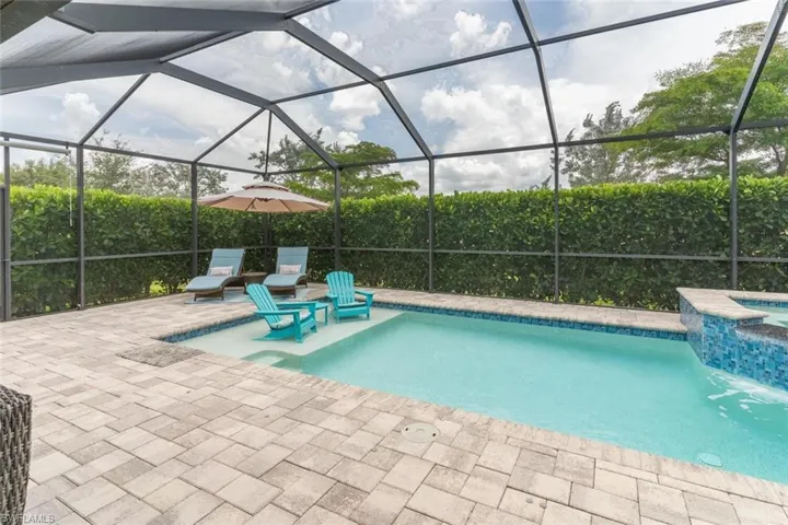 View of swimming pool with a lanai and a patio area