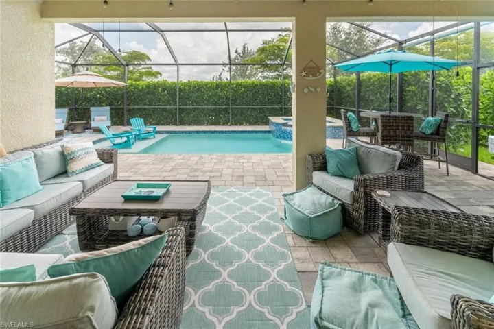 View of swimming pool with an outdoor living space, a lanai, and a patio area