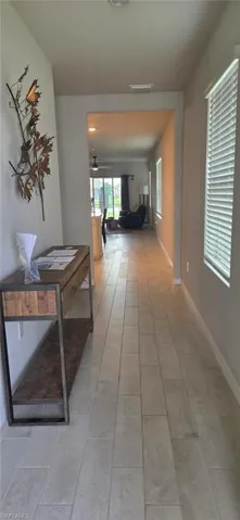 Open concept entry hall featuring plank-style tile flooring, neutral wall tones, and recessed lighting