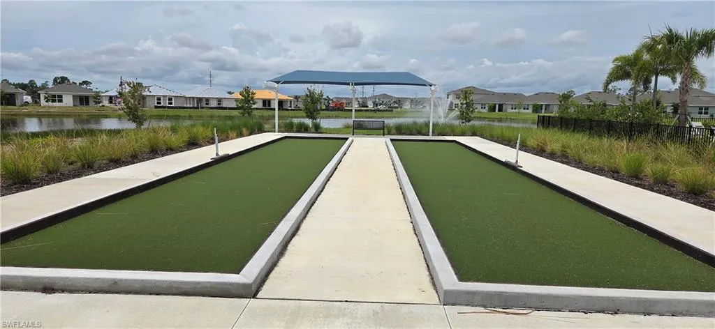 Dual bocce ball courts featuring artificial turf surfaces and concrete borders