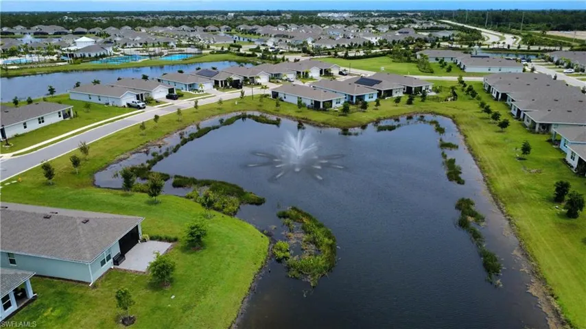 Expansive community featuring multiple tranquil ponds, a decorative water fountain, and paved roadways