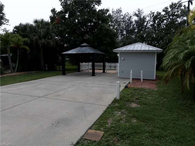 View of patio featuring a gazebo and concrete driveway