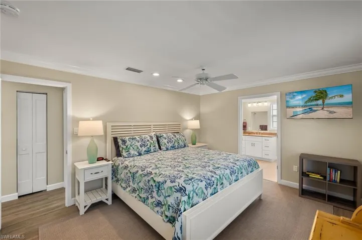 Bedroom with ornamental molding, visible vents, and baseboards