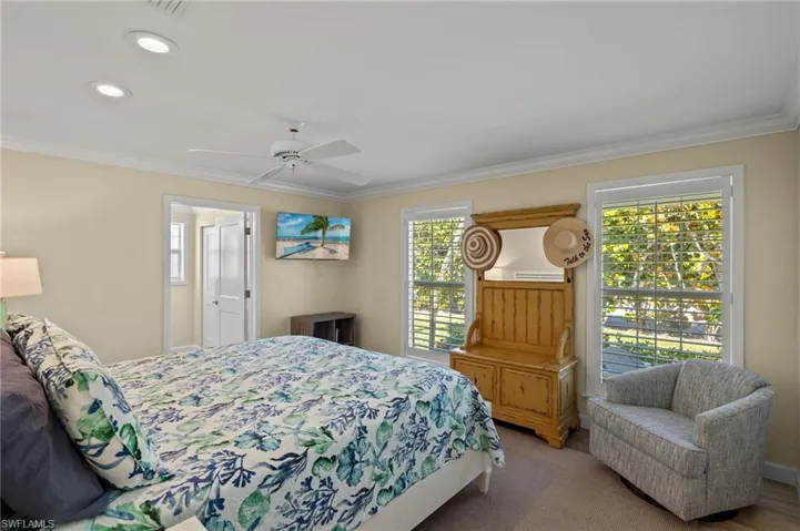 Bedroom featuring ornamental molding, recessed lighting, light colored carpet, and ceiling fan