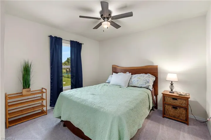 Living area with carpet flooring and a ceiling fan