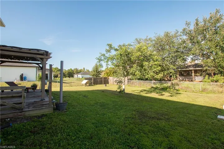 Fenced backyard with a wooden deck