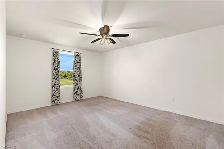 Bedroom featuring carpet flooring and a ceiling fan