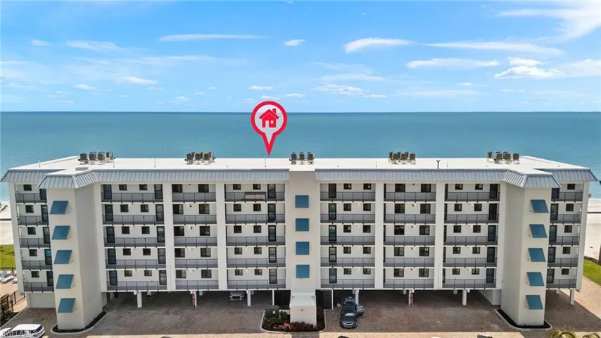Birds eye view of property with a water view