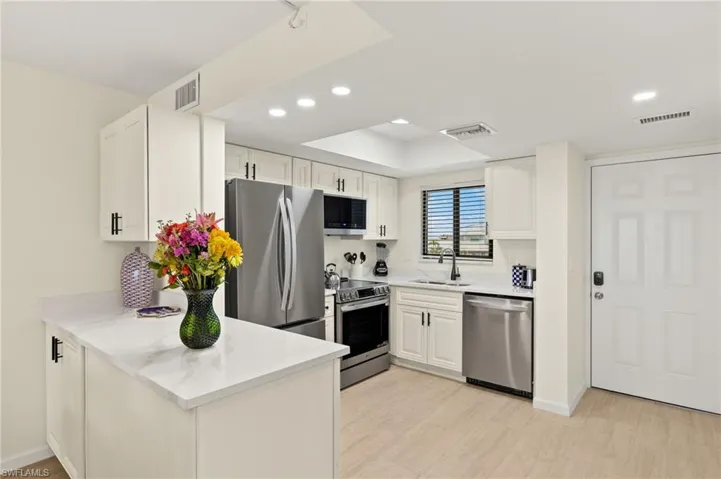 Kitchen featuring appliances with stainless steel finishes and recessed lighting