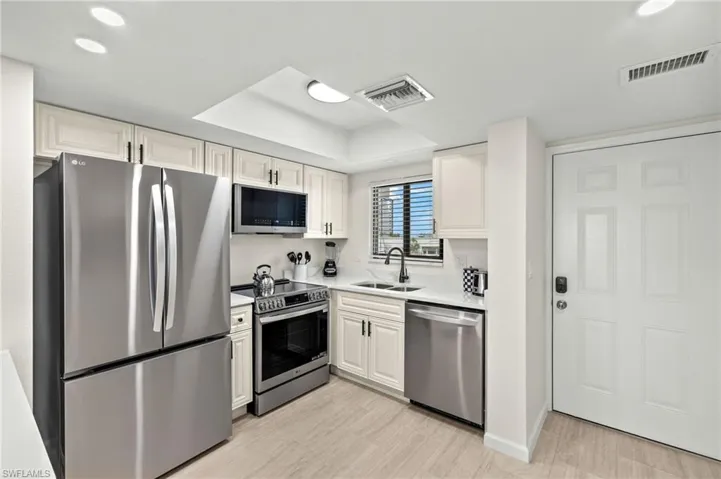 Kitchen with light countertops, stainless steel appliances