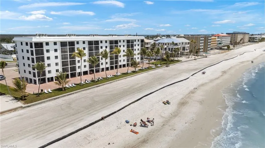 Birds eye view of property featuring a view of the beach and a water view