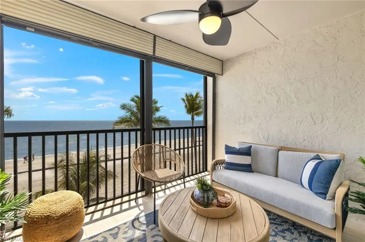 Sunroom featuring a beach view