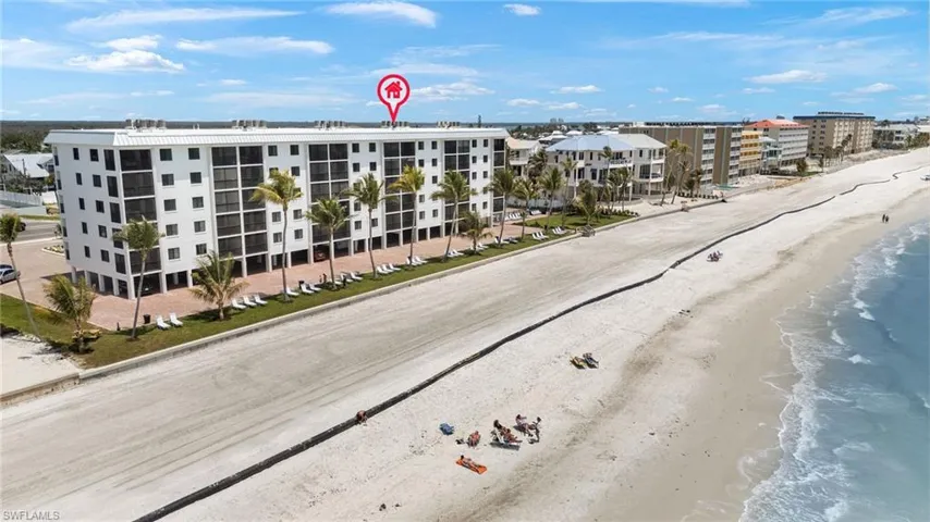 Birds eye view of property featuring a beach view and a water view