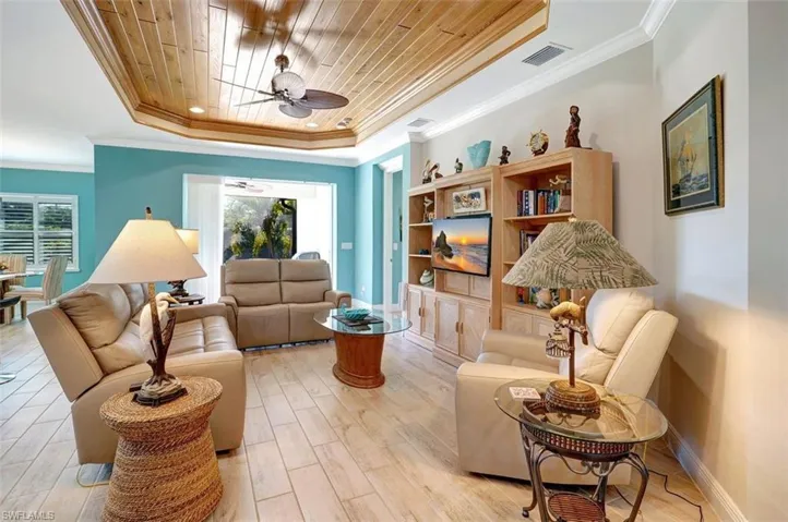 The family room welcomes planked flooring, shiplap ceiling, new furniture & ample space to sit, relax or watch television.