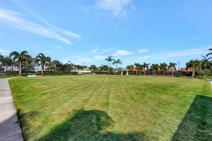 This is a large view of the side yard which leads to the back pickle ball & tennis courts.