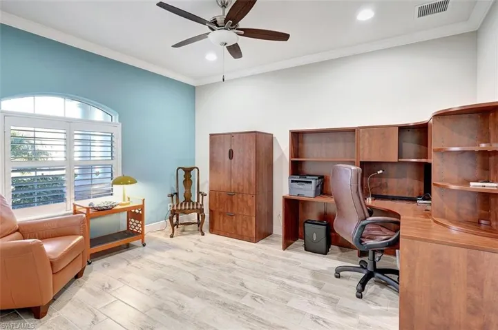 The office area is large with planked flooring, recessed lighting, freshly painted walls & an accent wall for the window area.
