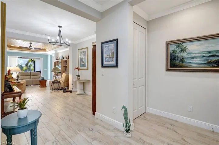 What a nice view of the spacious front foyer, planked flooring & home accessories.