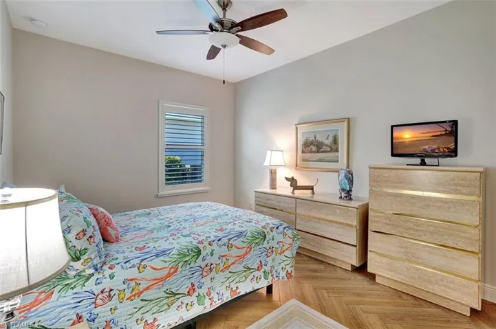 Take a rest in the second bedroom with planked flooring & plenty of light.