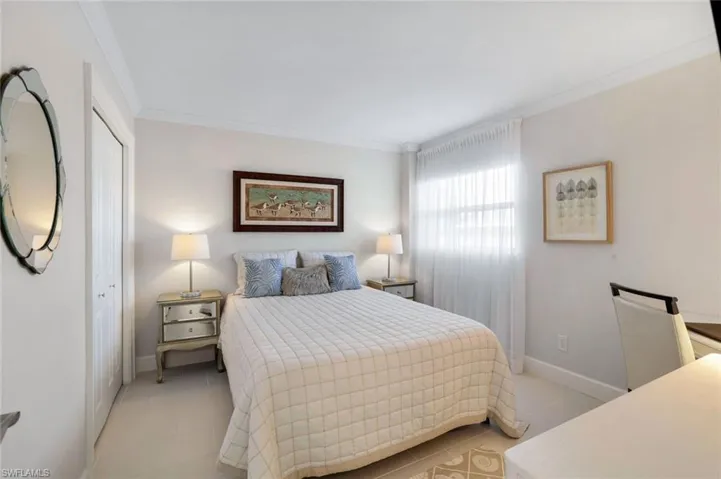 Guest  bedroom with crown molding, and tile floors. New queen size Sleep Number bed.
