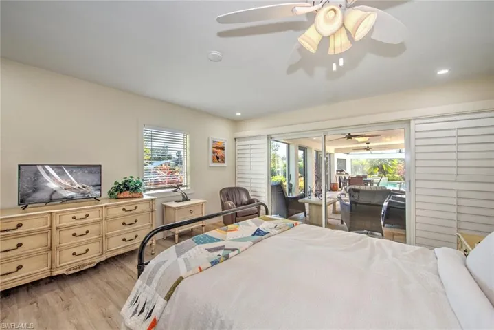 Bedroom with access to exterior, light hardwood / wood-style flooring, and ceiling fan