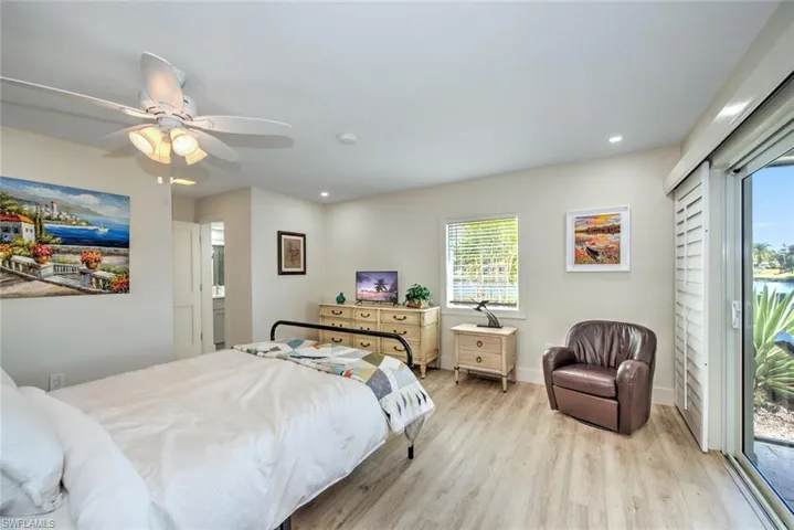 Bedroom with access to exterior, ceiling fan, and light hardwood / wood-style flooring
