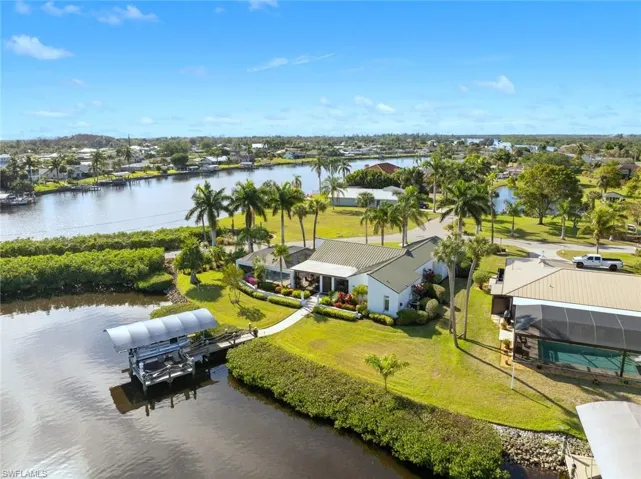 Birds eye view of property with a water view
