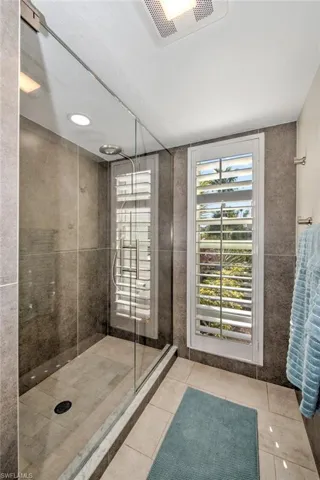 Bathroom with tile patterned floors and an enclosed shower