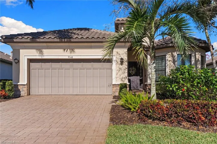 Mediterranean / spanish house featuring stone siding, an attached garage, decorative driveway, a tile roof, and stucco siding