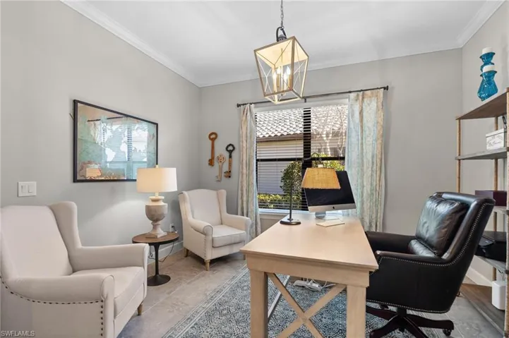 Office area featuring ornamental molding and hanging lights