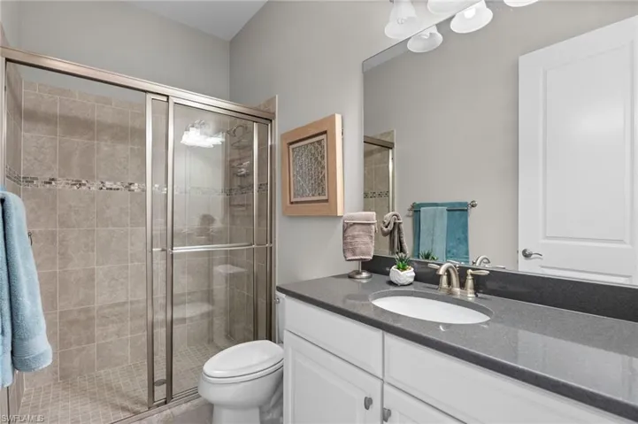 Bathroom with vanity and a stall shower
