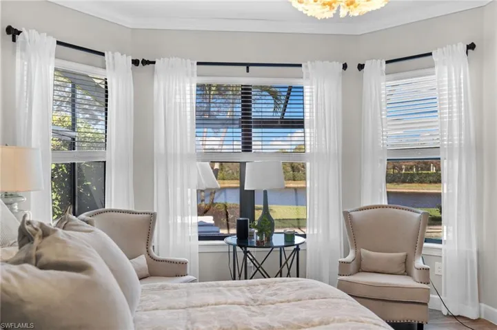 Bedroom featuring ornamental molding and a water view